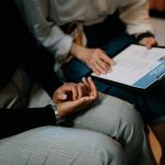 Two professionals reviewing a resume in an office setting, focused on teamwork.